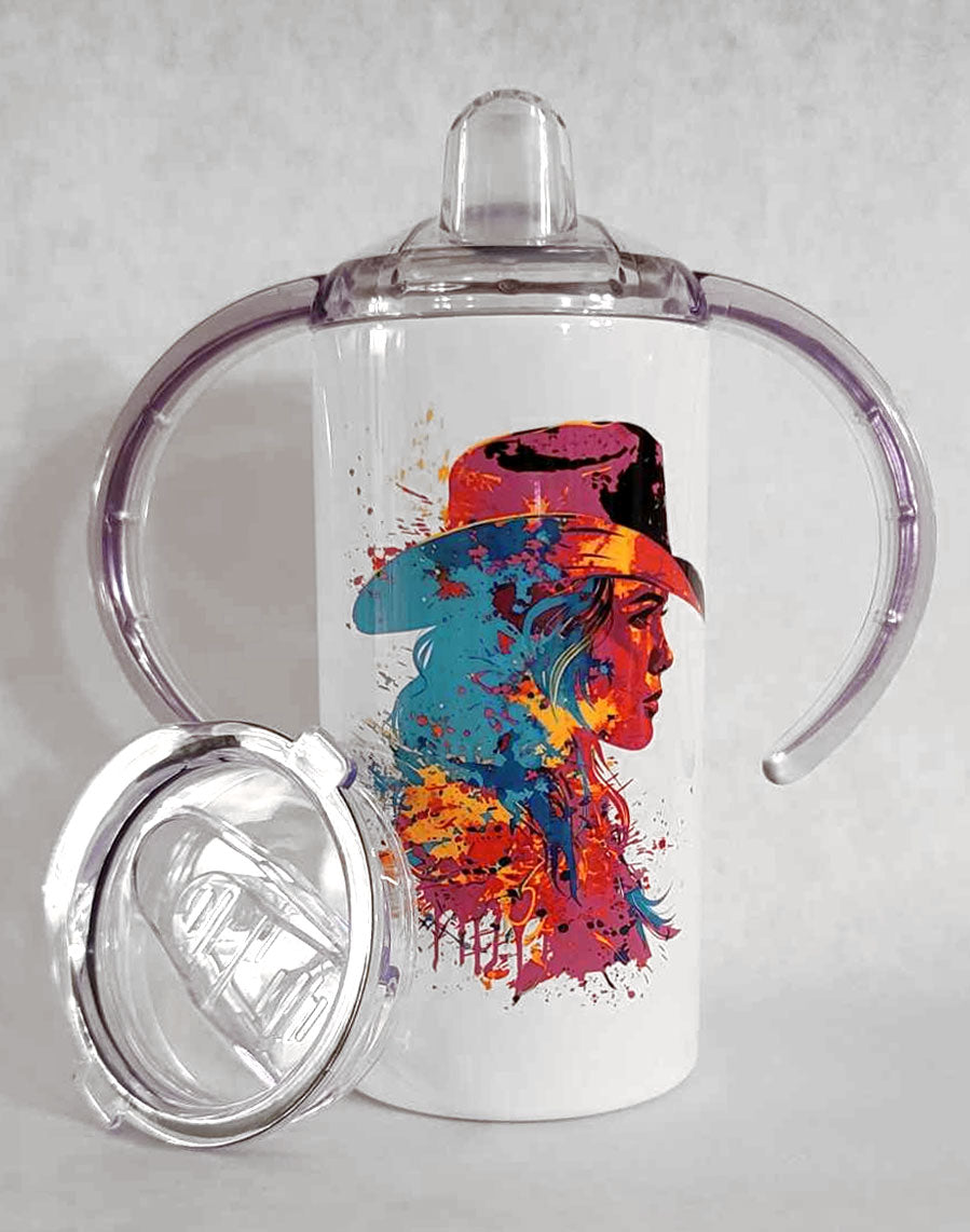 A children's western cowgirl style sippy cup tumbler entitled "The Neon Cowgirl", featuring a rich and vibrant paint splatter style profile image of a cowgirl in neon colors. 